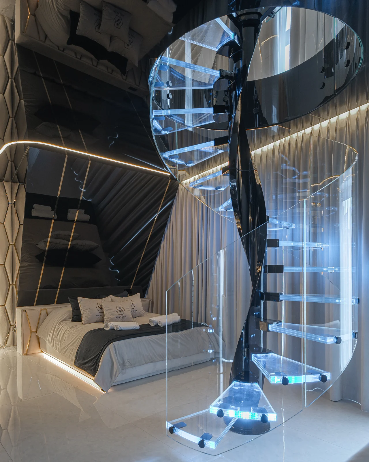 Spiral staircase with glass treads and blue lighting