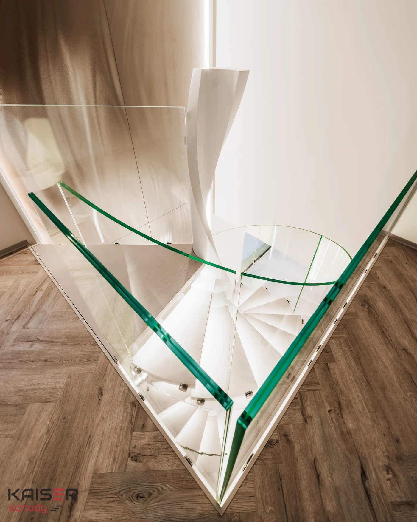 View from the upper floor of light-coloured stairs and a glass balustrade